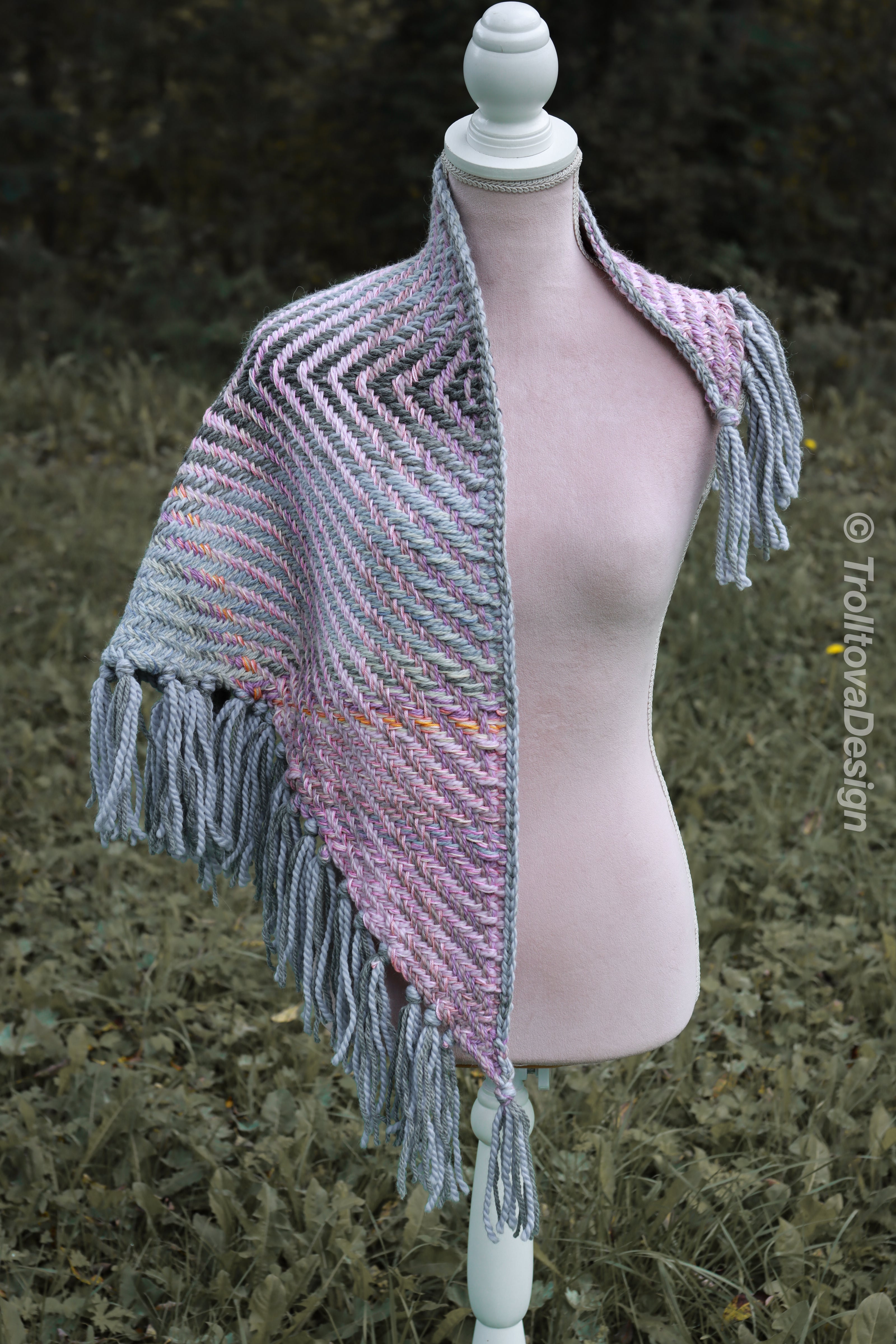 Handwoven triangle shawl made from yarn scraps.
