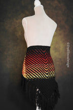 Handwoven triangle shawl made from yarn scraps.