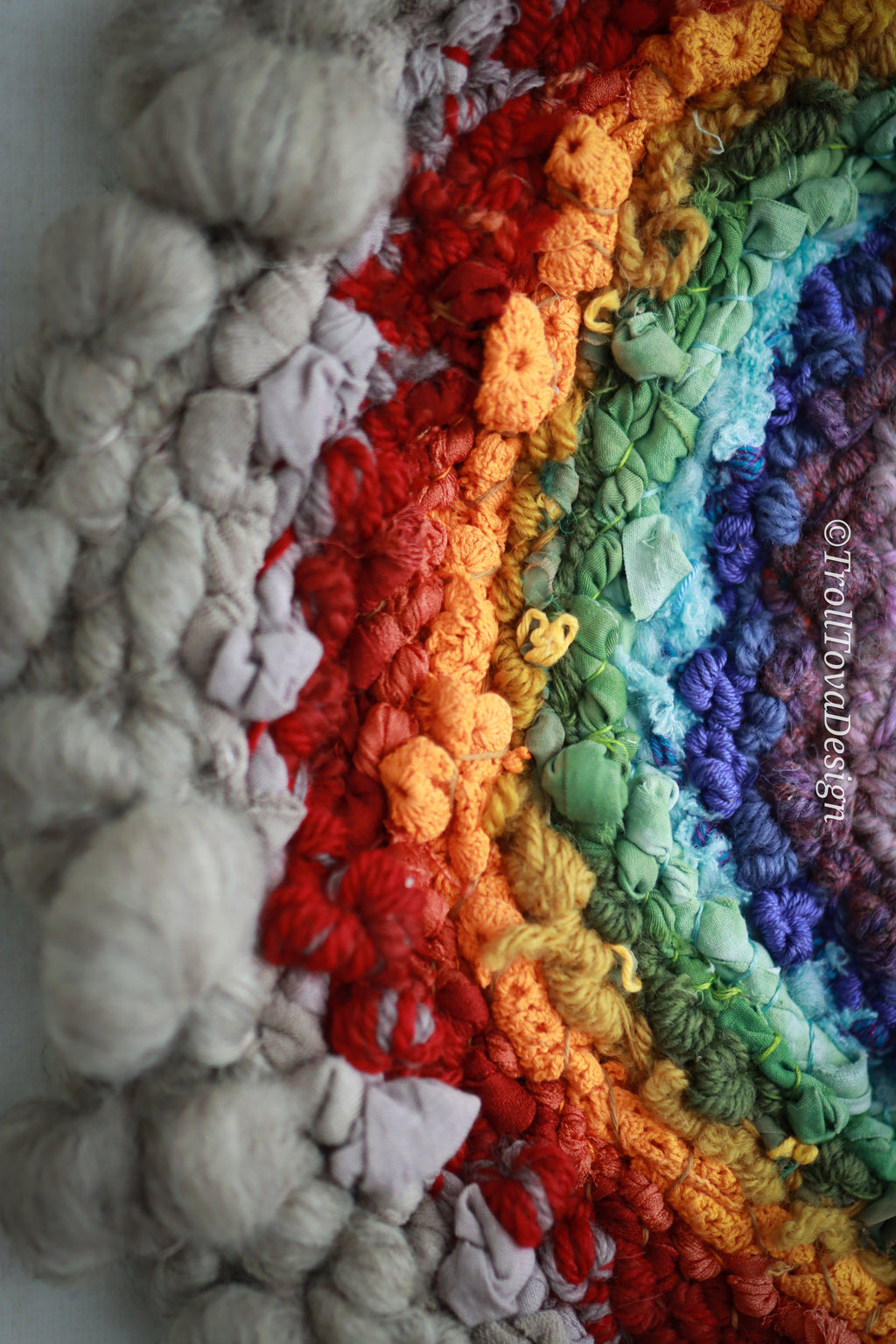One of a kind handmade textile wall art in gray and rainbow.