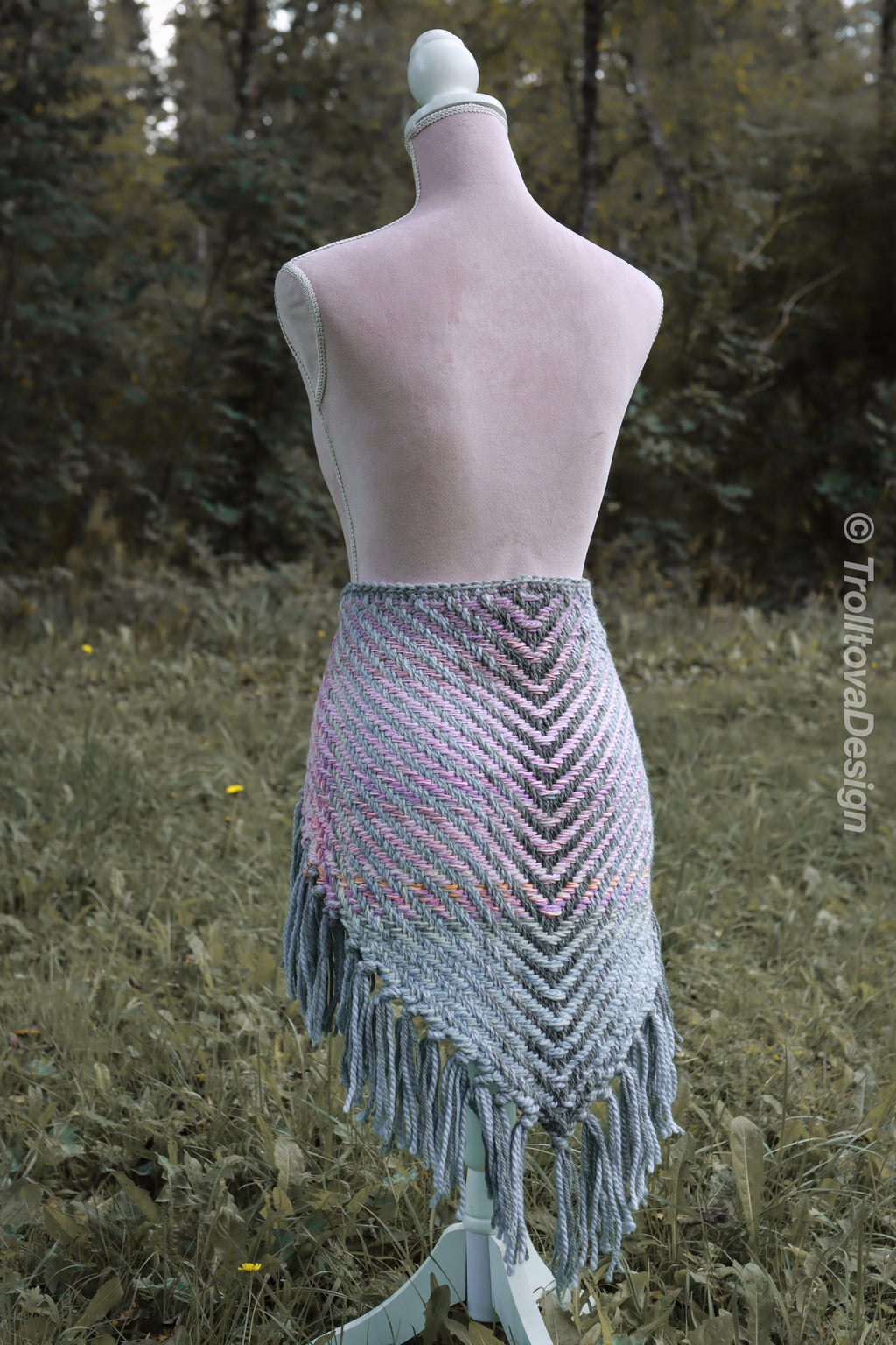 Handwoven triangle shawl made from yarn scraps.