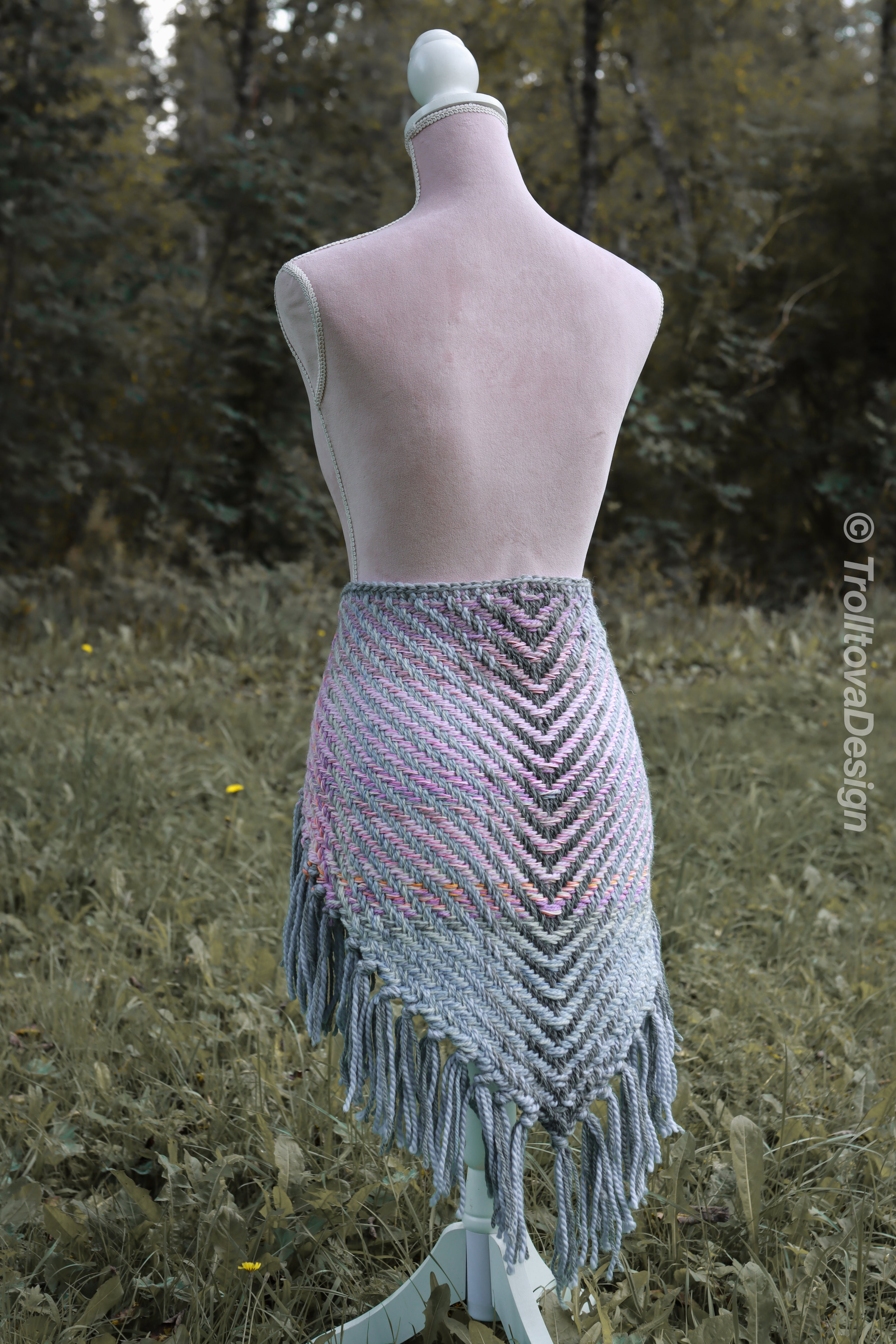 Handwoven triangle shawl made from yarn scraps.