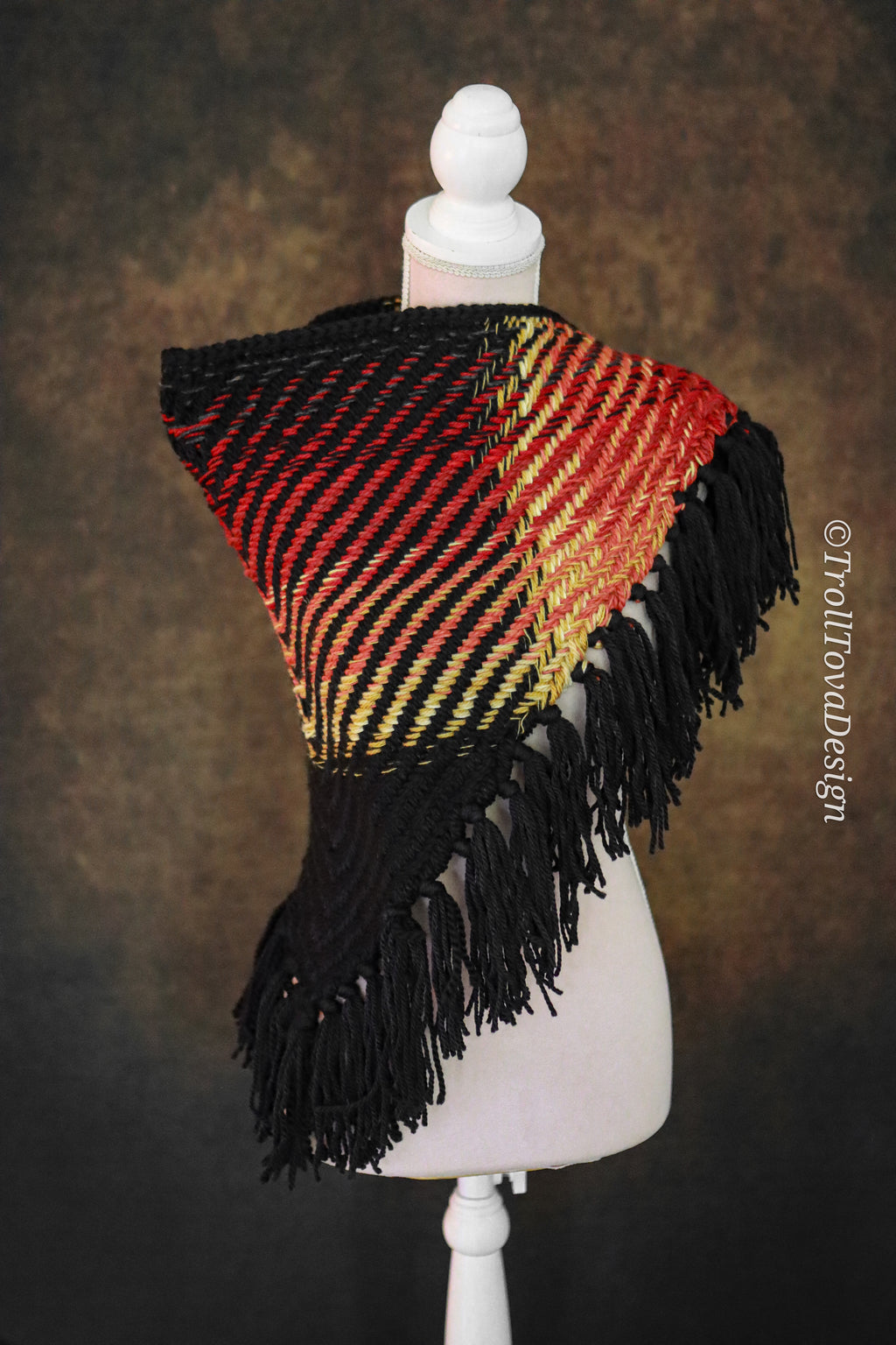 Handwoven triangle shawl made from yarn scraps.