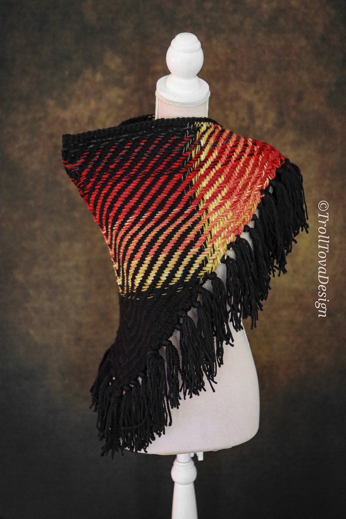 Handwoven triangle shawl made from yarn scraps.