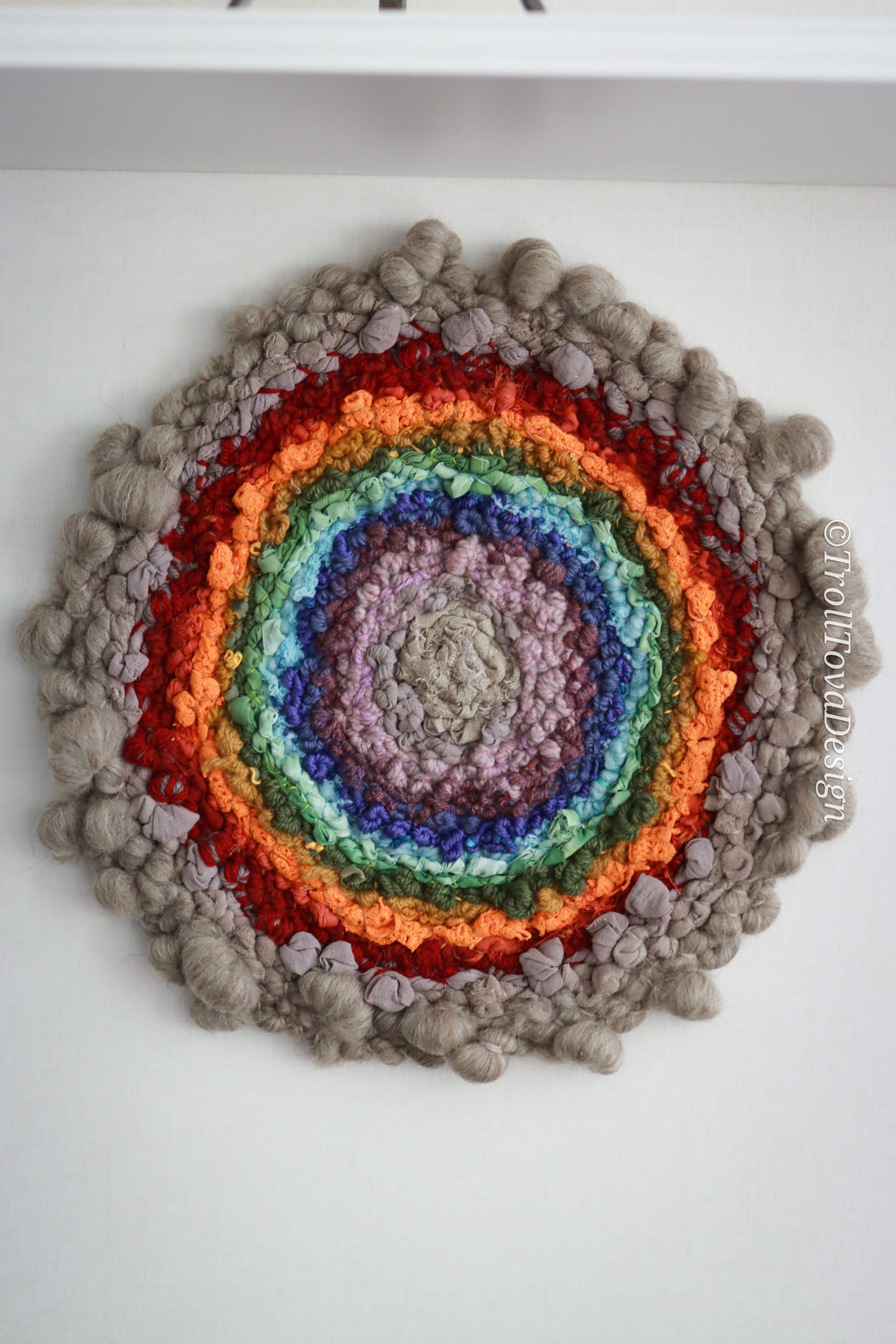 One of a kind handmade textile wall art in gray and rainbow.