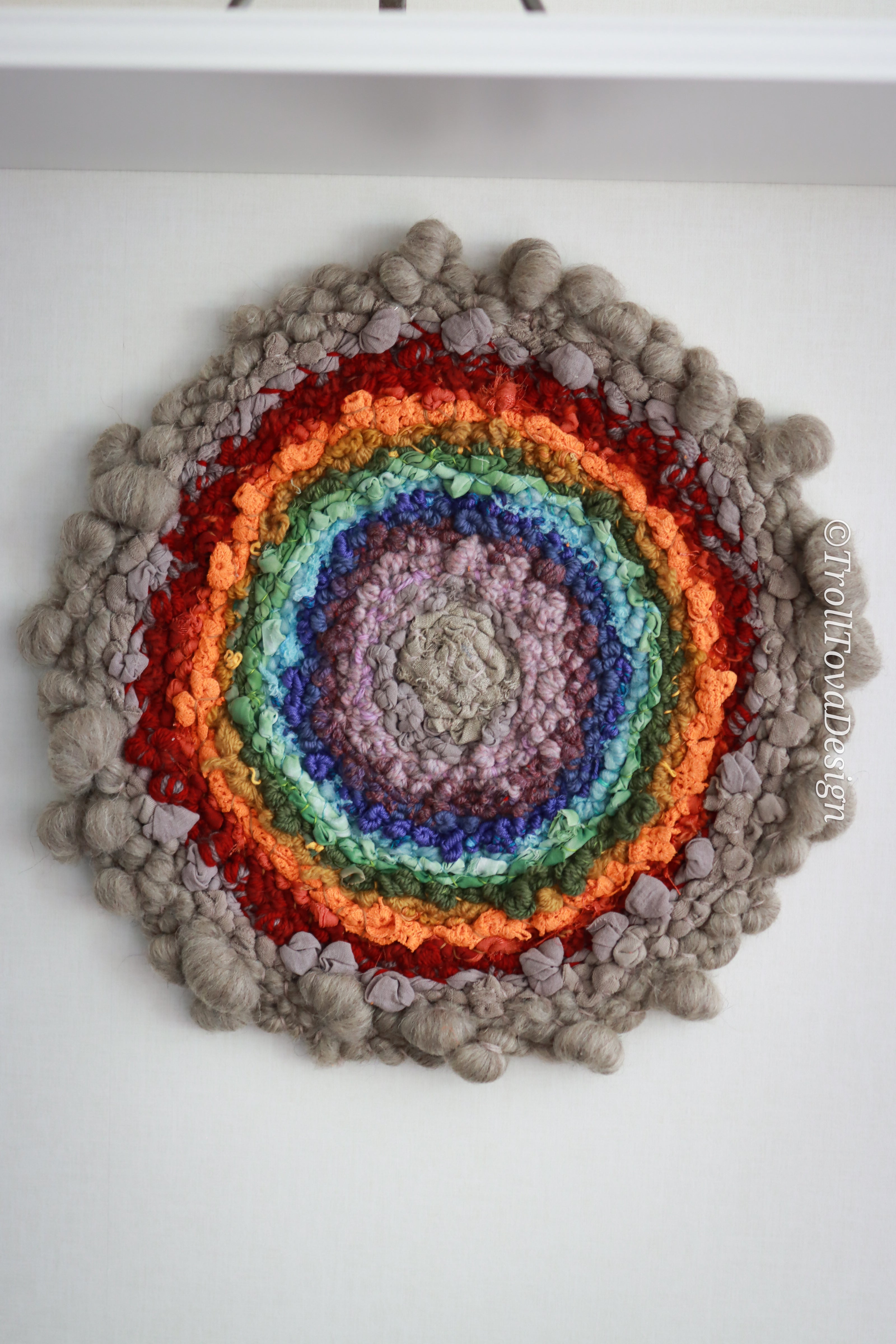 One of a kind handmade textile wall art in gray and rainbow.
