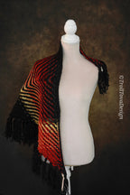 Handwoven triangle shawl made from yarn scraps.