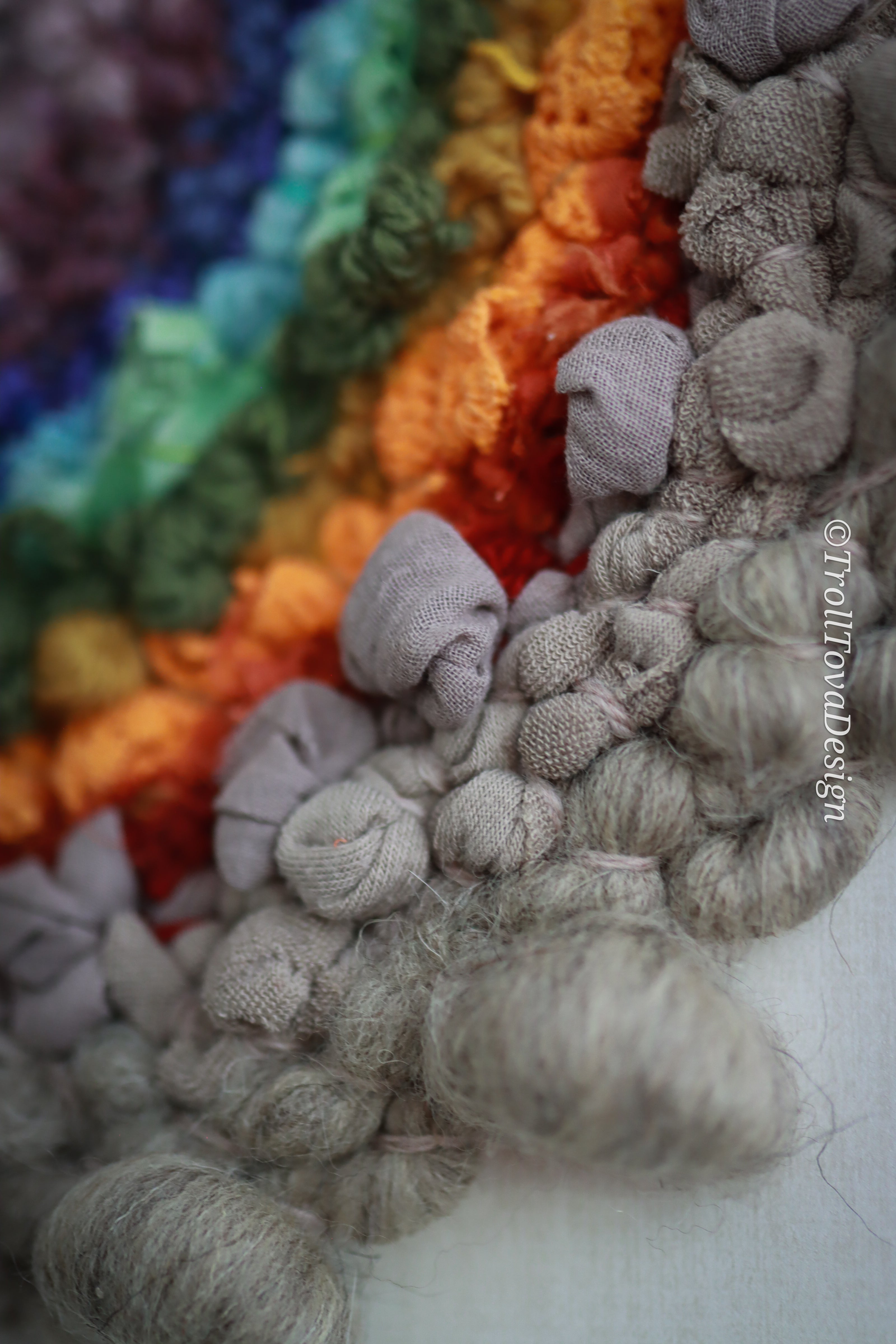 One of a kind handmade textile wall art in gray and rainbow.