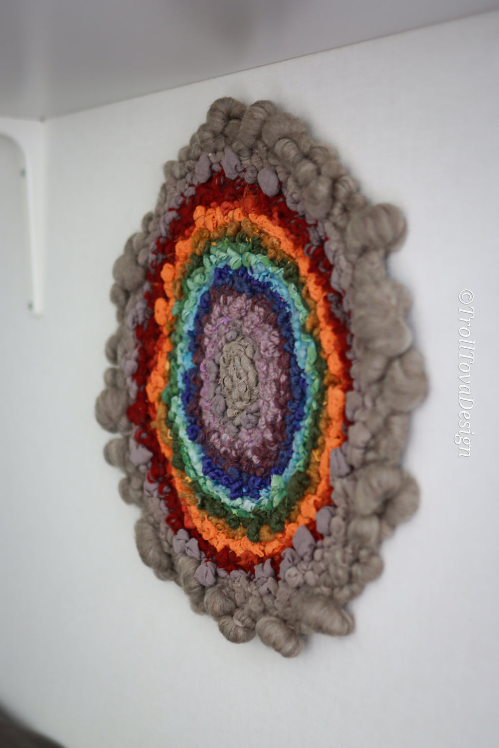 One of a kind handmade textile wall art in gray and rainbow.
