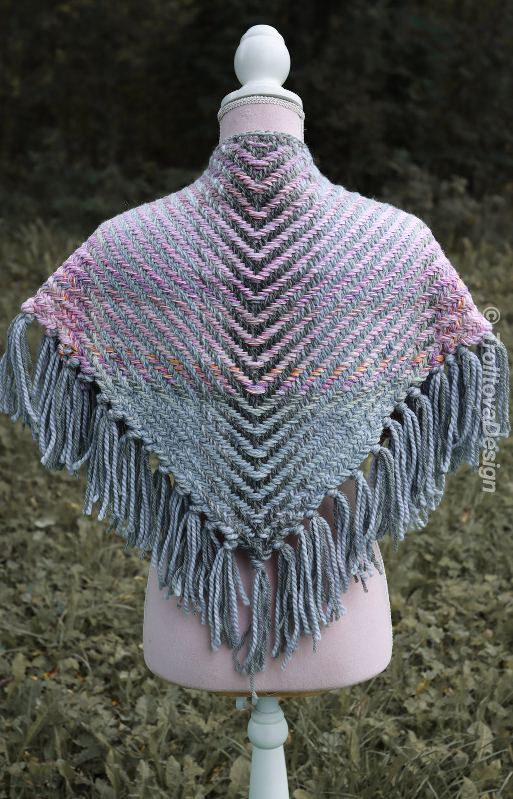 Handwoven triangle shawl made from yarn scraps.