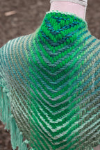 Handwoven triangle shawl made from yarn scraps.