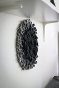 One of a kind handmade textile wall art in gray and black.