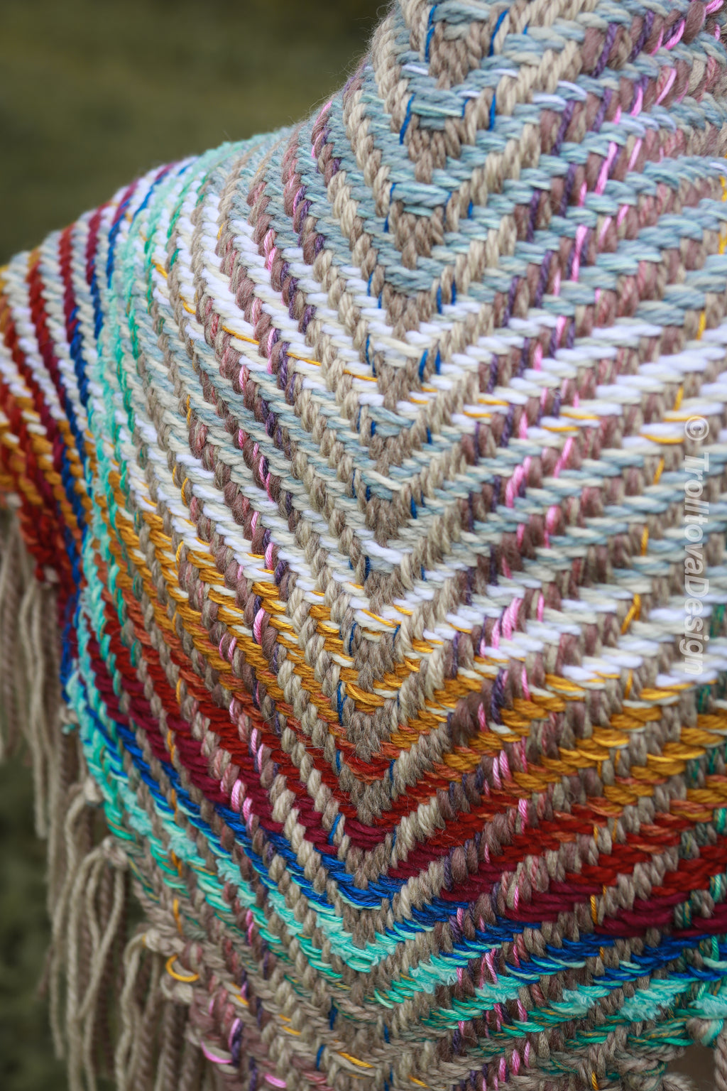 Handwoven triangle shawl made from yarn scraps.