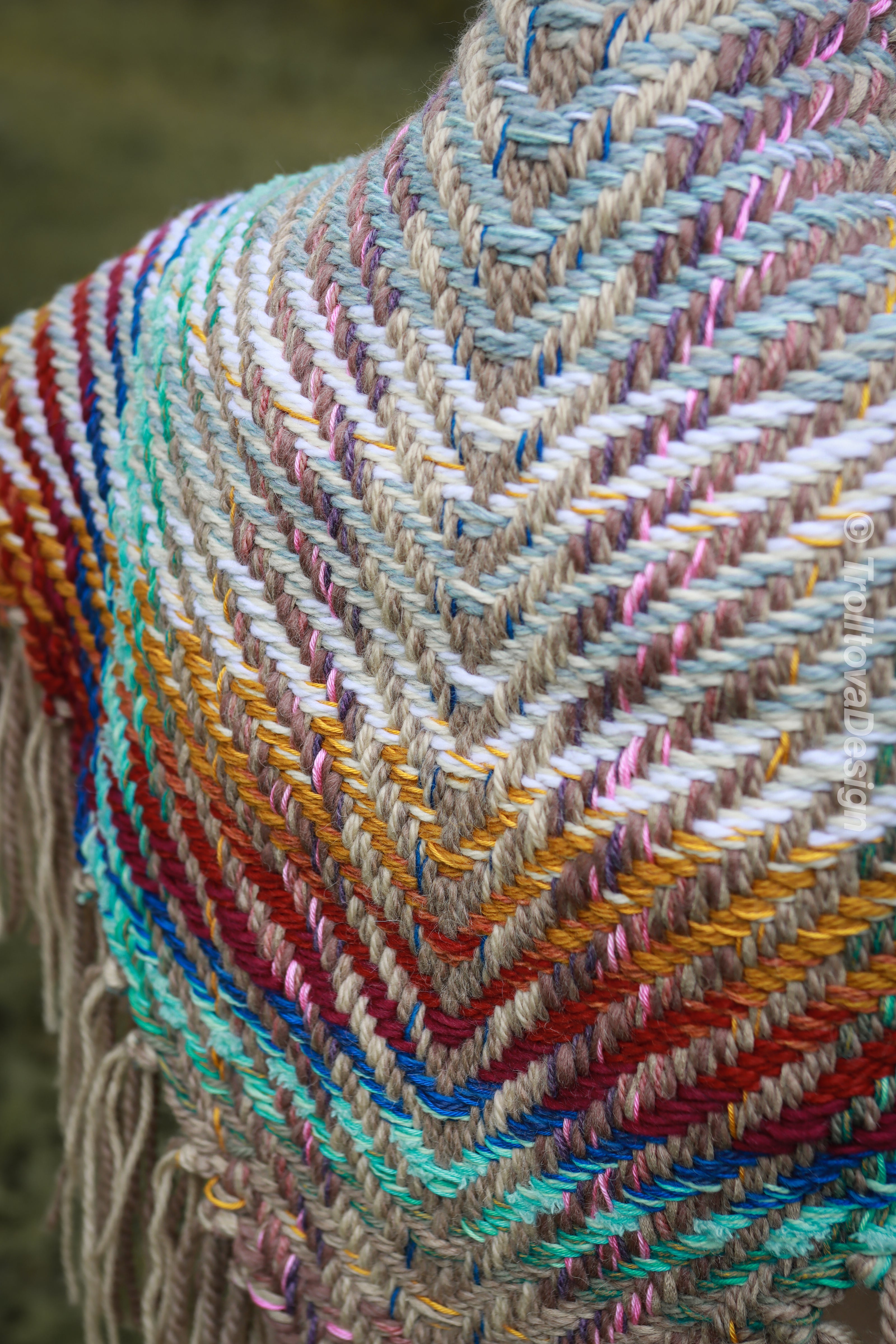 Handwoven triangle shawl made from yarn scraps.