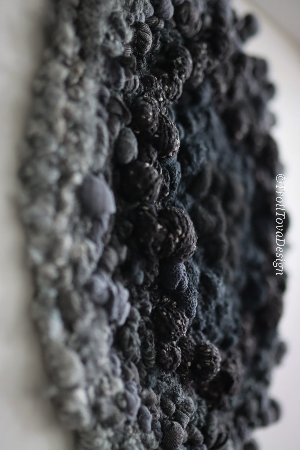 One of a kind handmade textile wall art in gray and black.