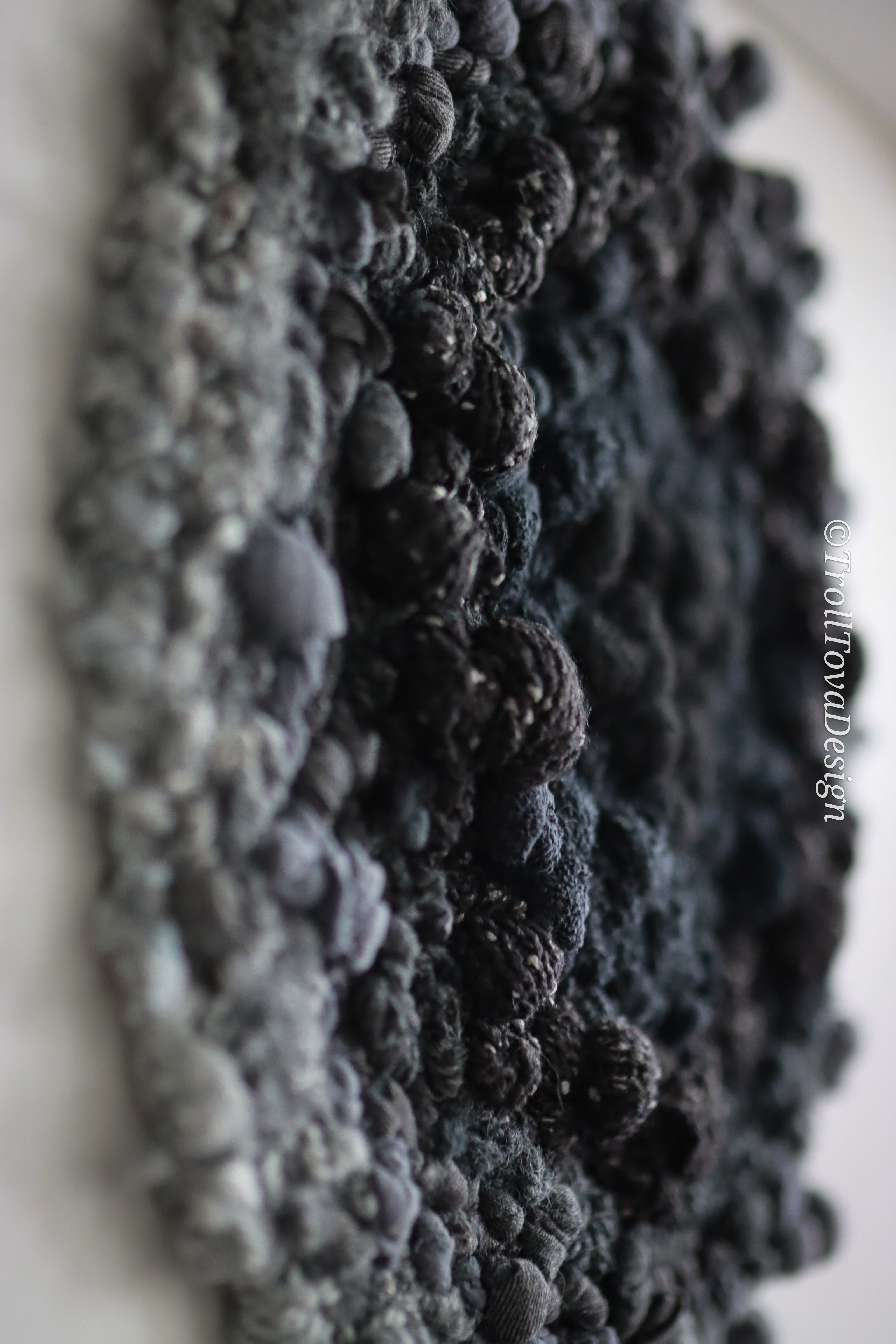 One of a kind handmade textile wall art in gray and black.