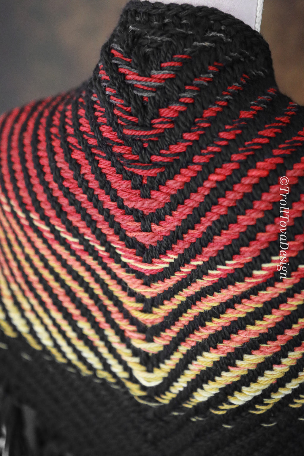 Handwoven triangle shawl made from yarn scraps.