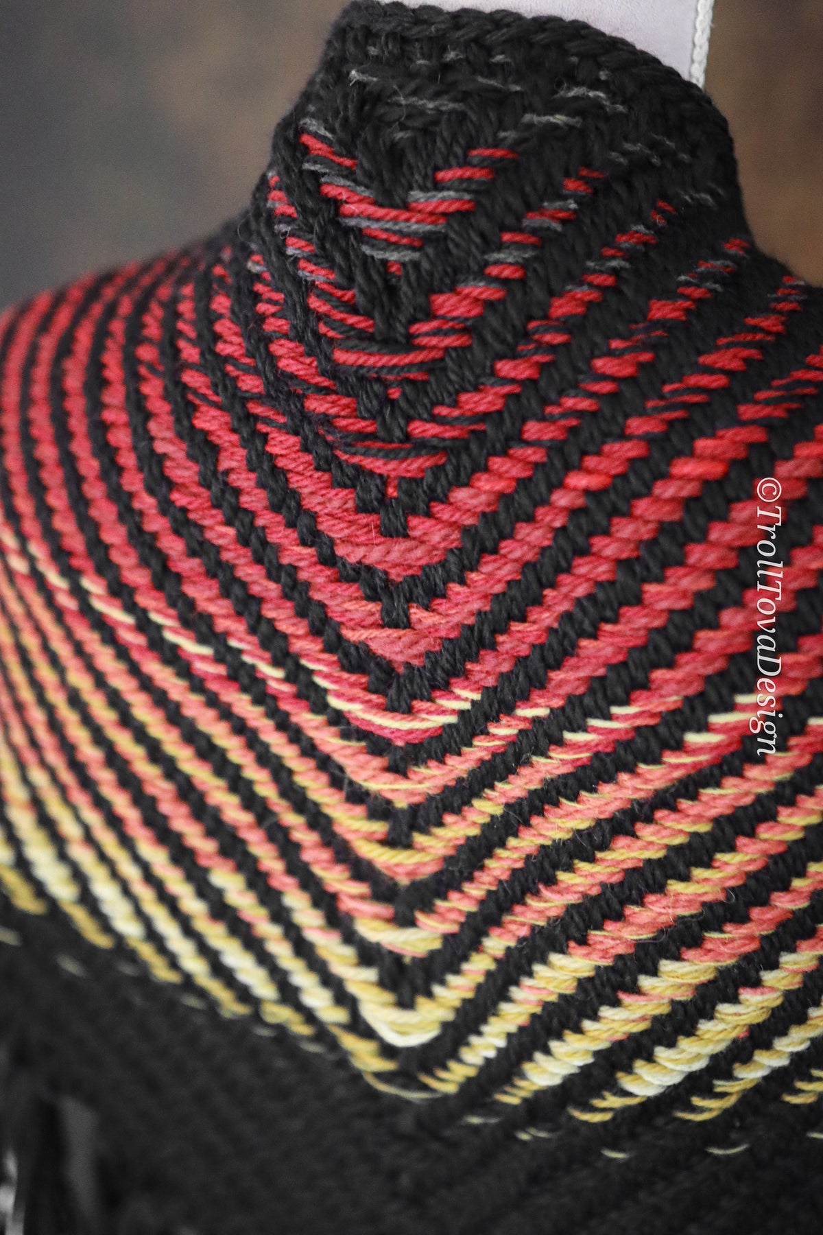 Handwoven triangle shawl made from yarn scraps.