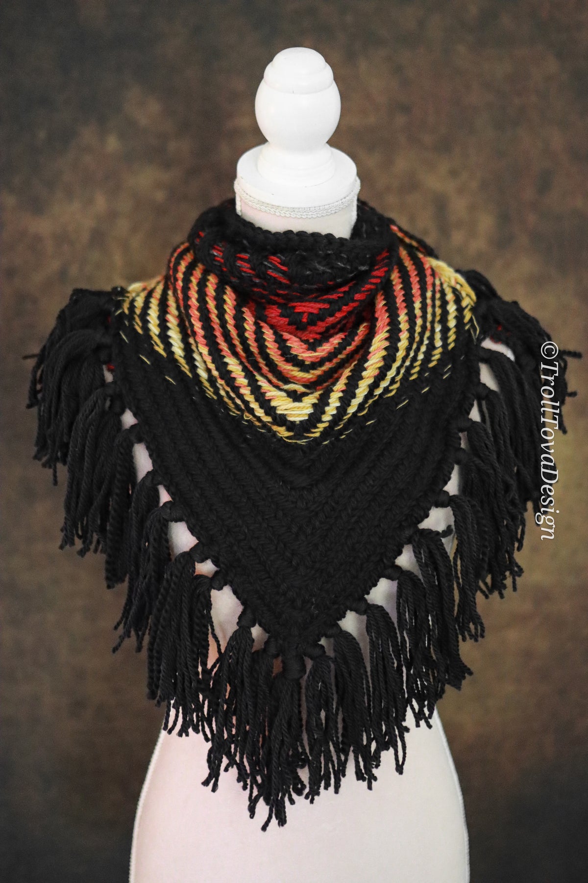 Handwoven triangle shawl made from yarn scraps.