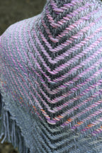 Handwoven triangle shawl made from yarn scraps.