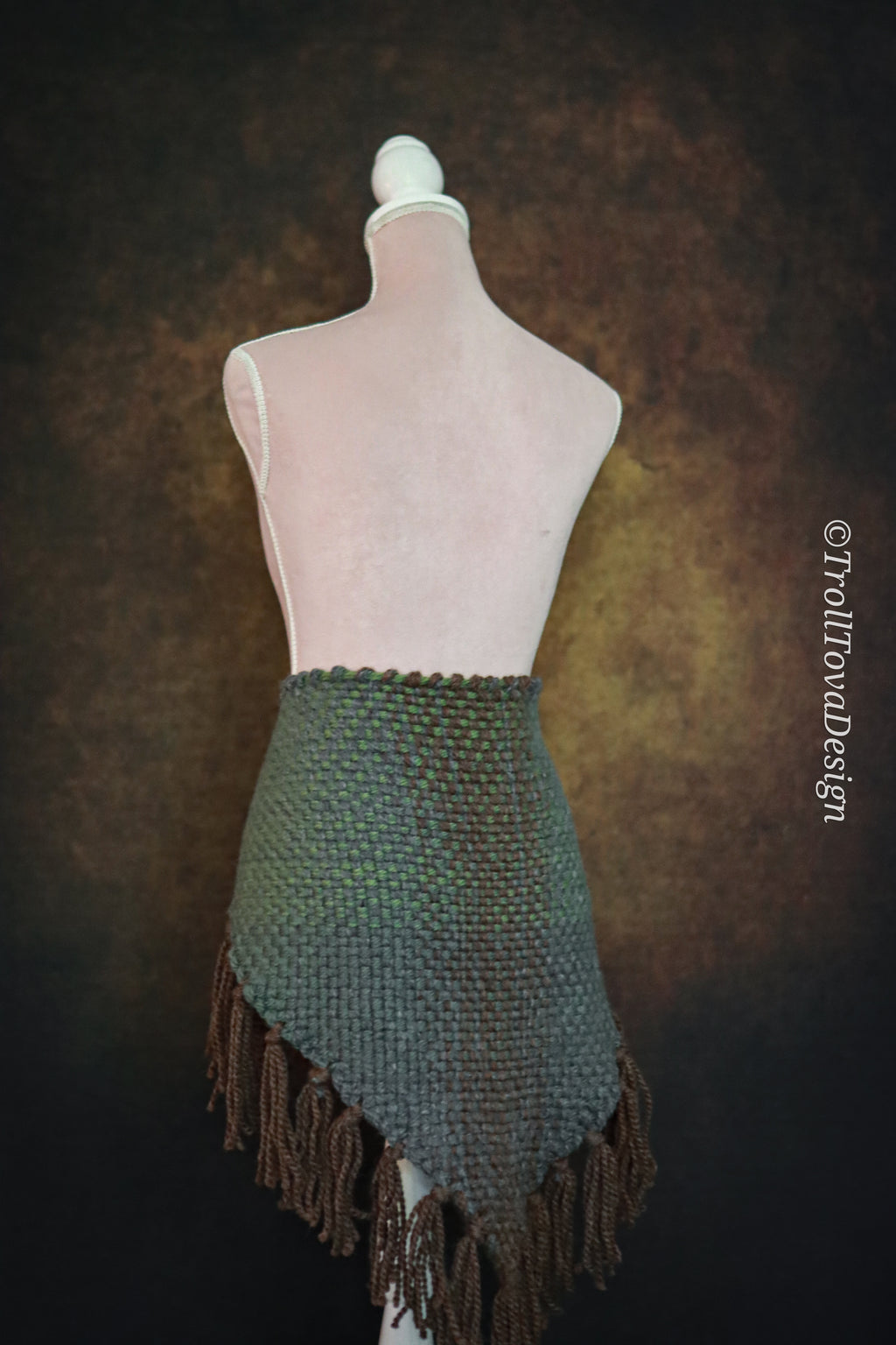 Handwoven triangle shawl made from yarn scraps.