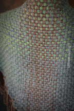 Handwoven triangle shawl made from yarn scraps.