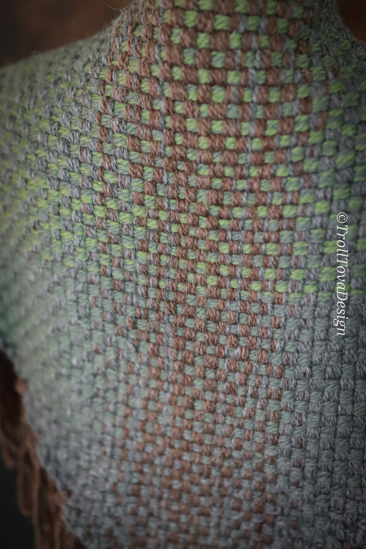 Handwoven triangle shawl made from yarn scraps.