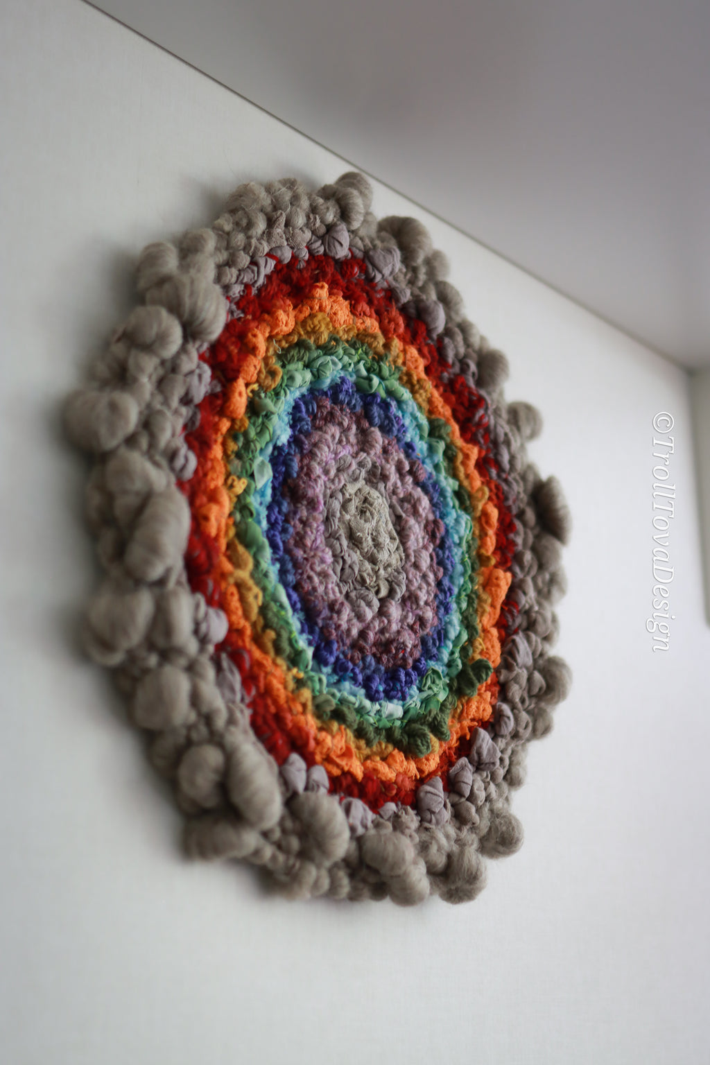 One of a kind handmade textile wall art in gray and rainbow.