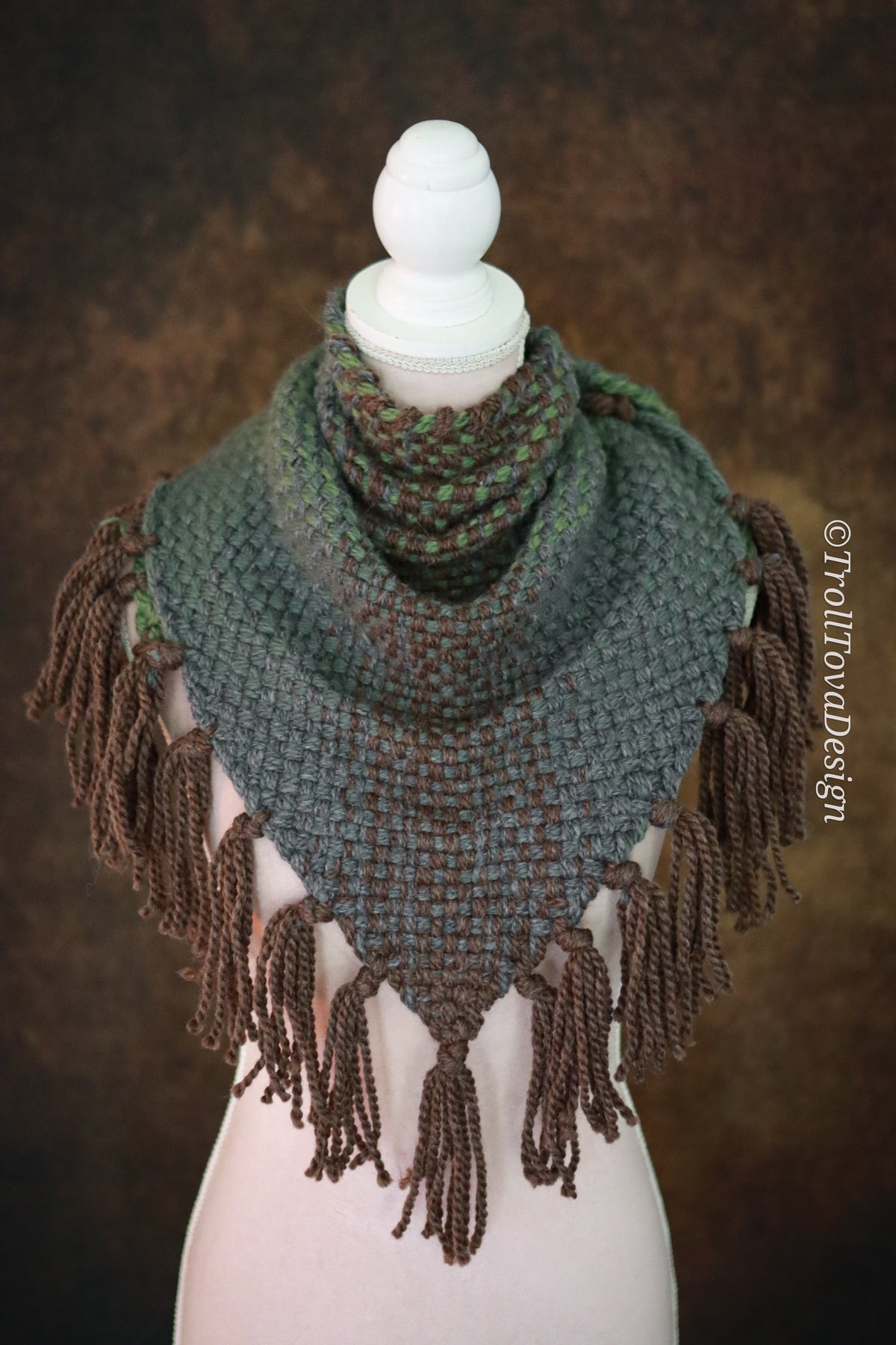 Handwoven triangle shawl made from yarn scraps.