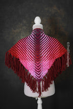 Handwoven triangle shawl made from yarn scraps.